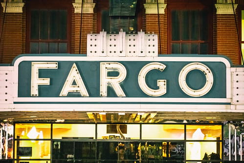 Old fashioned green and white theater sign that says Fargo