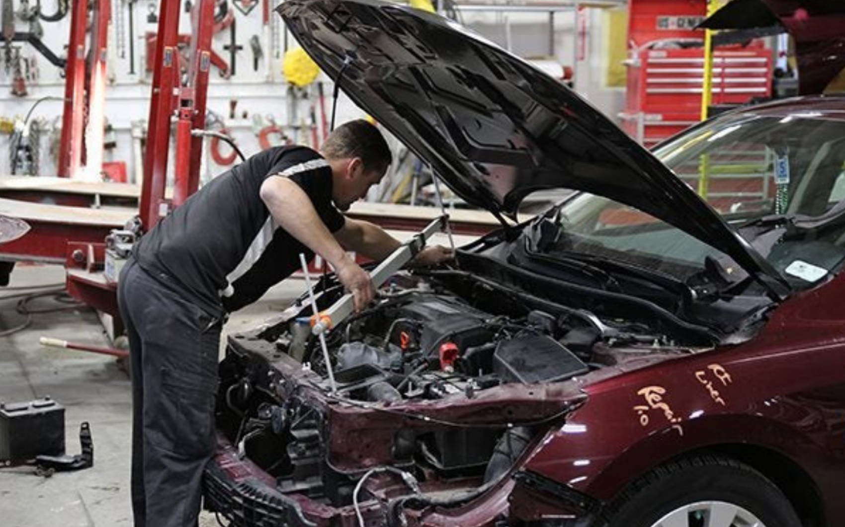 Certified Rydell car repair technician working on a vehicle involved in an accident.